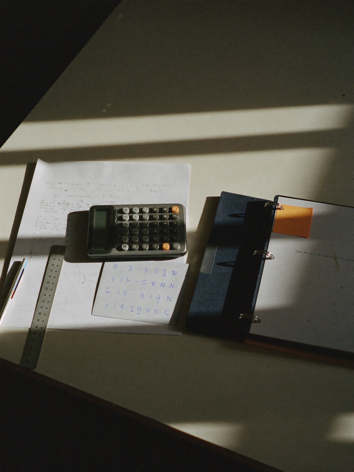 A VCE study desk with a calculator, formula sheet and binder