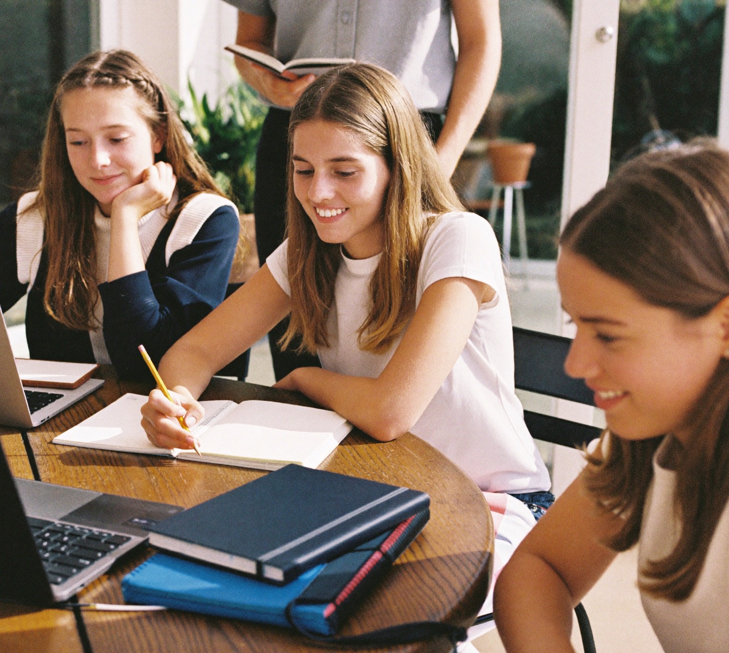 Year 10 students studying together with a tutor